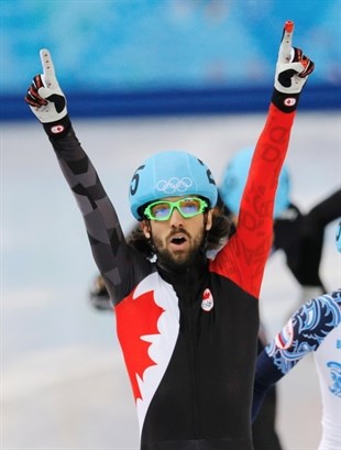 Charles Hamelin of Canada celebrates after winning the men's 1500m short track speedskating final at the Iceberg Skating Palace during the 2014 Winter Olympics, Monday, Feb. 10, 2014, in Sochi, Russia.