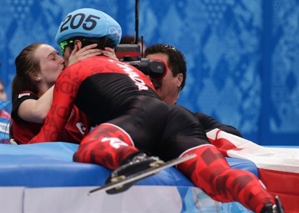 Charles Hamelin of Canada embraces Marianne St. Gelais after he won the men's 1500m short track speedskating final at the Iceberg Skating Palace during the 2014 Winter Olympics, Monday, Feb. 10, 2014, in Sochi, Russia.