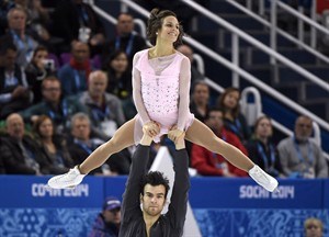 Canada's Meagan Duhamel and Eric Radford perform their short program during the pairs figure skating competition at the Sochi Winter Olympics Tuesday, February 11, 2014 in Sochi. 