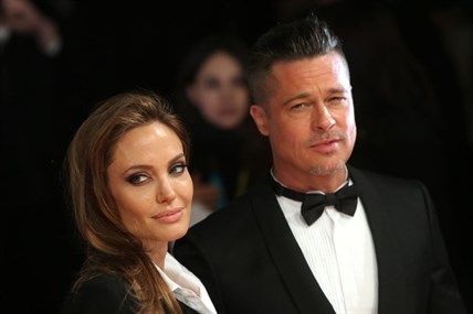 Angelina Jolie and Brad Pitt pose for photographers on the red carpet at the Bafta Awards in London.