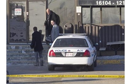 Police detectives investigate the scene where two people are dead and four people in hospital after a stabbing at a Loblaws warehouse in Edmonton, Alberta on Friday February 28, 2014.