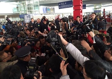In this photo released by China's Xinhua News Agency, reporters crowd at Terminal 3 of Beijing Capital International Airport in Beijing, China Saturday, March 8, 2014 following a report that a Malaysia Airlines Boeing 777-200 lost contact on a flight from Kuala Lumpur to Beijing.