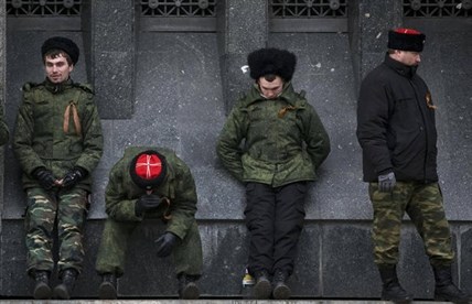 Cossacks guard the regional parliament building during the Crimean referendum in Simferopol, Ukraine, Sunday, March 16, 2014.