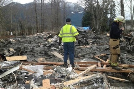 Fire fighters searching for victims in the homes hit by a mudslide in Snohomish Country on Saturday, March 22, 2014.