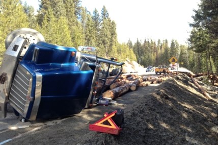 A logging truck flips and skids onto oncoming lane on Highway 33 her Beaverdell Monday morning.