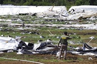 FILE - Josephine County Sheriff Dave Daniel stands amid the debris of plastic hoop houses destroyed by law enforcement, used to grow cannabis illegally, near Selma, Ore., on June 16, 2021. Foreign drug cartels that established illegal outdoor marijuana farms in Oregon last year are expanding to large indoor grows, a state police official said Thursday, May 12, 2022.
