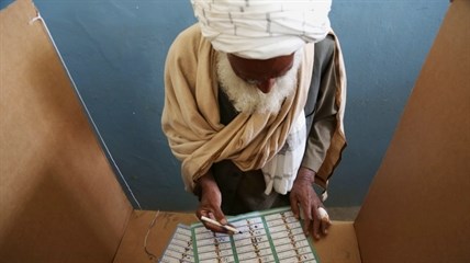 An Afghan man fills his ballot before voting at a polling station in Jalalabad, east of Kabul, Afghanistan, Saturday, April 5, 2014.
