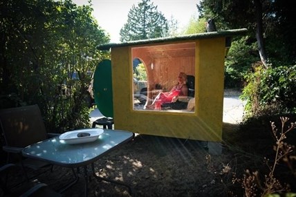 Anne Bruinn sits in her "Hobbit Hole Shed" that she and her husband offer for use to people who might want some time alone, in Vancouver, Friday, Sept. 2, 2022. 
