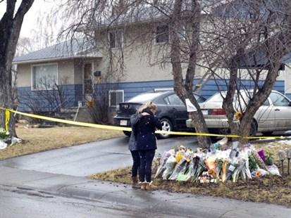 Jill Rogers, right, is comforted by mother Sherrie as they visit the scene of Tuesday's multiple fatal stabbings in northwest Calgary, Alberta on Friday, April 18, 2014.