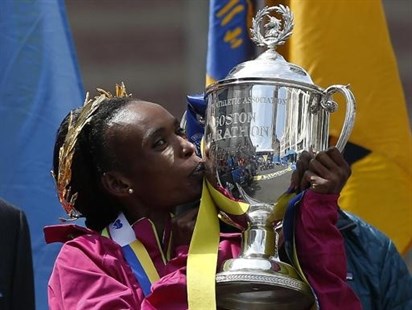 Rita Jeptoo, of Kenya, kisses the trophy after winning the women's division of the 118th Boston Marathon Monday, April 21, 2014 in Boston.