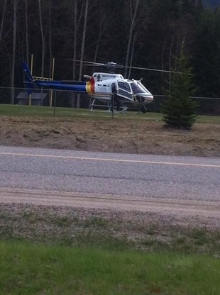 A RCMP helicopter lands in the field at Clearwater Secondary School on Monday, April 21, 2014.