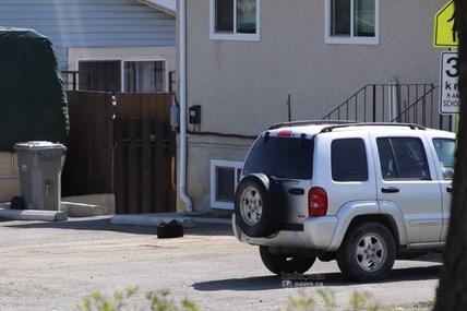 A black bag reported to police as a suspicious package waits in the driveway at 769 York Street for examination by the bomb squad April 30, 2014.