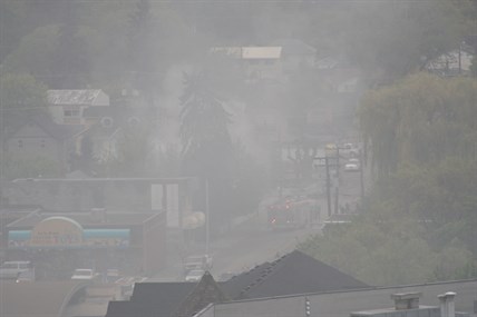 Smoke filled downtown Vernon from a house fire Saturday, May 3, 2014.