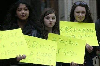 Members of a confirmation group from St Mary Magdalene, Bexhill-on-sea, pose with their placards in support of the campaign for the release of the kidnapped girls in Nigeria, outside Westminster Cathedral in London on Saturday, May 10, 2014.